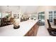 Kitchen with long countertops, and view to a dining area, living room, and patio at 3389 Pennyroyal Rd, Port Charlotte, FL 33953