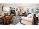 Cozy living room with neutral furniture, shutters, ceiling fan, and warm lighting at 3389 Pennyroyal Rd, Port Charlotte, FL 33953
