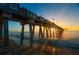 Picturesque pier at sunset over the ocean, a perfect backdrop for a relaxing evening stroll at 3389 Pennyroyal Rd, Port Charlotte, FL 33953