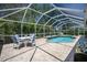 Screened-in pool offers a private outdoor space with an adjacent seating area at 3389 Pennyroyal Rd, Port Charlotte, FL 33953
