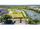 Aerial view of community tennis courts and lush green landscaping at 3389 Pennyroyal Rd, Port Charlotte, FL 33953