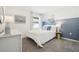 A bright bedroom featuring a bed with a blue accent wall at 3424 Montano Ave, Spring Hill, FL 34608