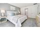 This is a primary bedroom with white bedding and a gray accent wall at 3424 Montano Ave, Spring Hill, FL 34608