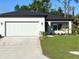 Beautiful single-story home featuring a well-manicured lawn, two-car garage, and a modern design at 2370 Allsup Ter, North Port, FL 34286