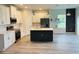 Modern kitchen with stainless steel appliances, white cabinets, and an island at 2370 Allsup Ter, North Port, FL 34286
