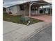 Tan-sided single-story home with a carport, offering covered parking and easy access at 8343 Fantasia Park Way, Riverview, FL 33578