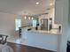 Modern kitchen with a stainless steel refrigerator, white cabinets, and stylish pendant lights at 8343 Fantasia Park Way, Riverview, FL 33578