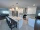 Updated kitchen with stainless steel appliances, a large island, and modern light fixtures at 8343 Fantasia Park Way, Riverview, FL 33578
