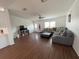 Inviting living room with wood floors, ceiling fan, and a large sectional sofa at 8343 Fantasia Park Way, Riverview, FL 33578