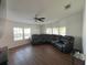 Open living room with hardwood floors, large sectional couch, ceiling fan and lots of natural light at 8343 Fantasia Park Way, Riverview, FL 33578