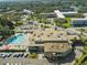 Aerial view of a resort community with a pool, clubhouse, lush landscaping, and ample parking at 2401 Ecuadorian Way # 45, Clearwater, FL 33763