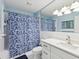 Bright bathroom featuring ample lighting, a vanity with white cabinets, and a shower with a patterned curtain at 2401 Ecuadorian Way # 45, Clearwater, FL 33763