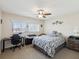 Bedroom with ceiling fan, window providing natural light, and desk with chair offering study space at 2401 Ecuadorian Way # 45, Clearwater, FL 33763