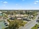 Aerial shot of building with ample parking, surrounded by mature trees and manicured lawns at 2401 Ecuadorian Way # 45, Clearwater, FL 33763