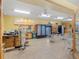The cafe features tables with chairs, drink coolers, menu sign, and light tile flooring at 2401 Ecuadorian Way # 45, Clearwater, FL 33763