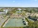 Aerial view featuring tennis courts, shuffleboard, ample parking, and the surrounding community buildings at 2401 Ecuadorian Way # 45, Clearwater, FL 33763