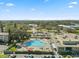 Community pool aerial view showing its unique design and surrounded by parking and greenery at 2401 Ecuadorian Way # 45, Clearwater, FL 33763