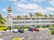 Charming condo building featuring a unique tower, well-maintained landscaping, and ample parking at 2401 Ecuadorian Way # 45, Clearwater, FL 33763