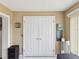 Hallway with double doors, neutral paint, and tile flooring at 2401 Ecuadorian Way # 45, Clearwater, FL 33763
