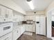 Bright kitchen featuring white cabinets, modern appliances, and a stylish backsplash at 2401 Ecuadorian Way # 45, Clearwater, FL 33763