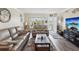 Cozy living room featuring wood floors, neutral paint, large windows, and comfortable seating at 2401 Ecuadorian Way # 45, Clearwater, FL 33763