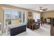 Neutral toned living area featuring tile floors, bright windows, recliner and storage chest at 2401 Ecuadorian Way # 45, Clearwater, FL 33763