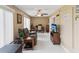 A neutral toned living area with tile floors, a desk area, recliner and a TV at 2401 Ecuadorian Way # 45, Clearwater, FL 33763