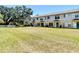 Spacious backyard view of attached homes, complemented by lush green grass at 4510 Limerick Dr, Tampa, FL 33610