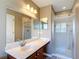 Bright bathroom features a marble countertop vanity with a shower behind glass doors at 4510 Limerick Dr, Tampa, FL 33610