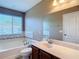 Bathroom features a soaking tub, a single vanity, and a window for natural light at 4510 Limerick Dr, Tampa, FL 33610
