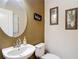 Charming half-bathroom with a stylish sink and decorative wall art at 4510 Limerick Dr, Tampa, FL 33610