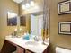 A bathroom features a vanity with sink, mirror, and decorative accents at 4510 Limerick Dr, Tampa, FL 33610