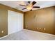 Bedroom features carpet, ceiling fan, and closet space at 4510 Limerick Dr, Tampa, FL 33610