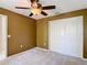 Bedroom with carpet, ceiling fan, and closet space at 4510 Limerick Dr, Tampa, FL 33610