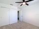 Spacious bedroom featuring neutral carpeting, ceiling fan and closet at 4510 Limerick Dr, Tampa, FL 33610