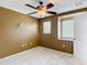 Carpeted bedroom with ceiling fan and natural light from two windows at 4510 Limerick Dr, Tampa, FL 33610