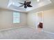 Spacious carpeted bedroom with trey ceiling, ceiling fan and ensuite bathroom at 4510 Limerick Dr, Tampa, FL 33610