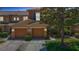 Charming townhome featuring a two-car garage, landscaped front yard, and neutral exterior paint at 4510 Limerick Dr, Tampa, FL 33610