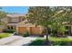 Charming townhome with two-car garage and mature trees in a manicured front yard at 4510 Limerick Dr, Tampa, FL 33610