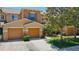 Townhome featuring a two-car garage and well-maintained landscaping at 4510 Limerick Dr, Tampa, FL 33610