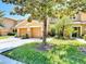 Well-maintained townhome featuring two-car garage, lush lawn and mature trees at 4510 Limerick Dr, Tampa, FL 33610