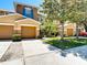 Inviting townhome showcasing well-manicured landscaping, mature trees, and a private two-car garage at 4510 Limerick Dr, Tampa, FL 33610