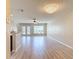Bright and spacious living room boasting wood floors, high ceilings with a chandelier, and natural light from the glass doors at 4510 Limerick Dr, Tampa, FL 33610