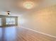Bright living room featuring hardwood floors, a ceiling fan, and large windows for ample natural light at 4510 Limerick Dr, Tampa, FL 33610