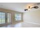 Cozy living room with a ceiling fan, large windows and French doors at 4510 Limerick Dr, Tampa, FL 33610
