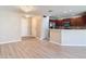 Open-concept living room featuring tiled floors, modern lighting, and access to the kitchen at 4510 Limerick Dr, Tampa, FL 33610