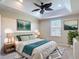 Relaxing primary bedroom with a tray ceiling, a ceiling fan, and ample natural light at 4510 Limerick Dr, Tampa, FL 33610