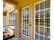 View of the patio featuring glass paneled door and window with a view to the green lawn at 4510 Limerick Dr, Tampa, FL 33610