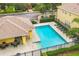 Community pool with a lounge area, surrounded by lush greenery and a well-maintained building at 4510 Limerick Dr, Tampa, FL 33610