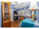 Bedroom featuring plantation shutters, a ceiling fan, and a desk area for added functionality at 1928 Cove Pointe Drive, Venice, FL 34293